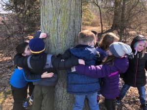 second graders hugging tree_Kellogg Trail