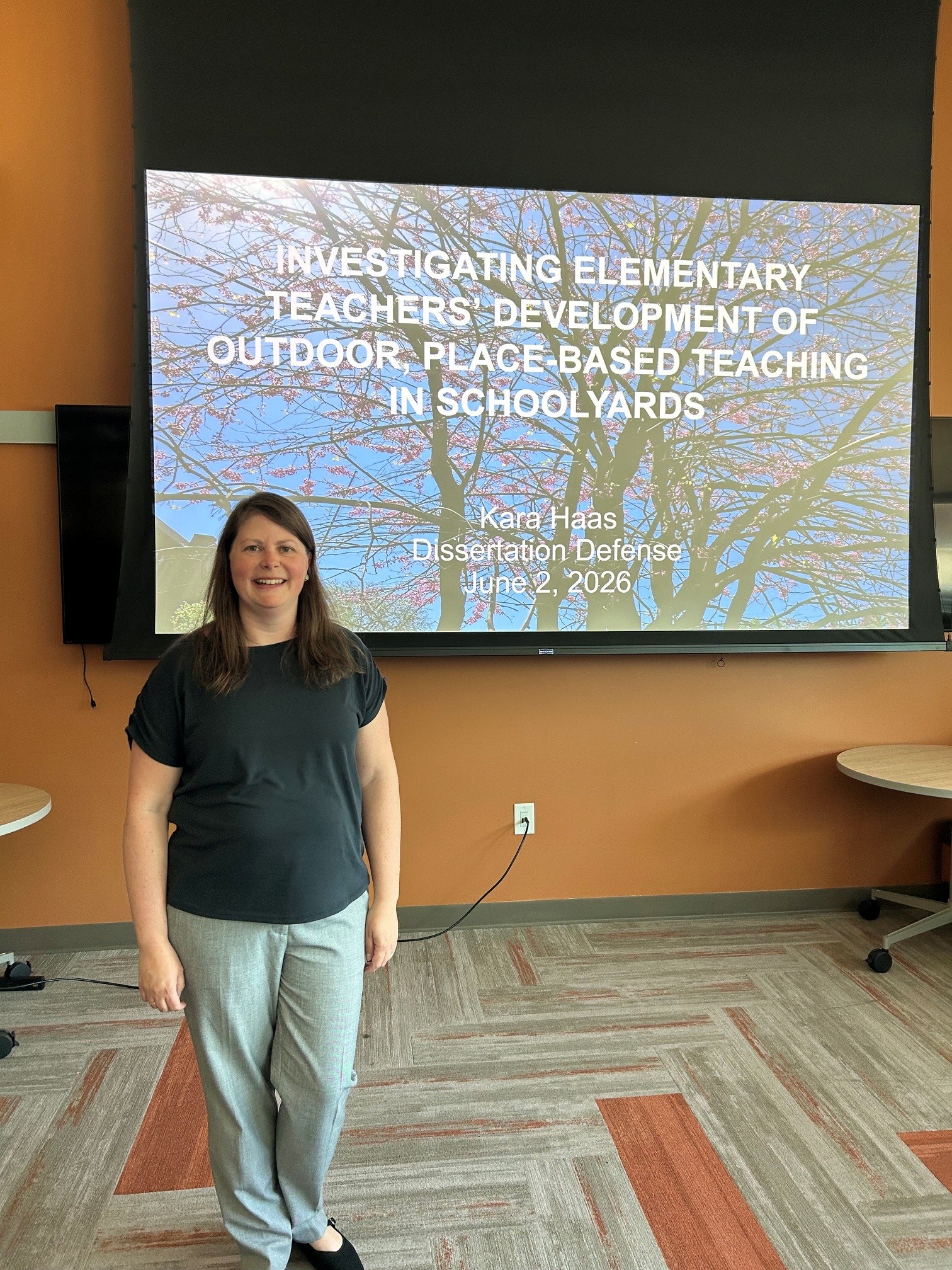 Kare in front of dissertation defense slide